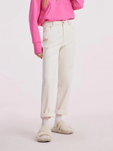 a lady in white pipe jeans